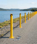 4 Pack 48 Inch Yellow Steel Safety Bollards With 16 Anchor Bolts Built Tough For Driveway Barrier And Storefront Protection Heavy Duty Parking Posts For Smooth Daily Traffic Control by a waterway.