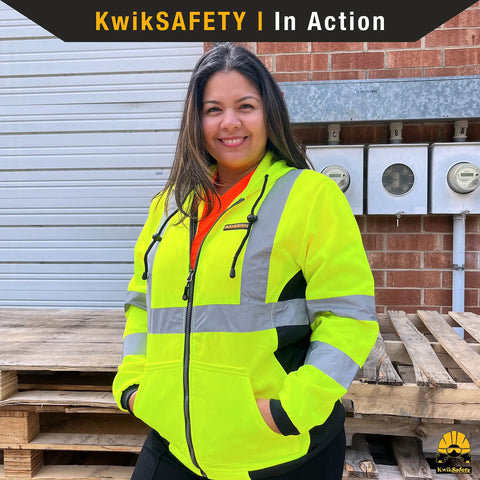 Woman wearing ROGUE Safety Jacket for Women With Class 3 ANSI Reflective Hi Vis Fleece Hoodie Yellow Small Size Two Front Pockets Adjustable Drawcord Heavy Duty Zipper for Day and Night Work.