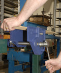 Beefy 7 Inch Quick Release Woodworking Vise With Heavy Duty Cast Iron Body in use on bench, showing clamping mechanism