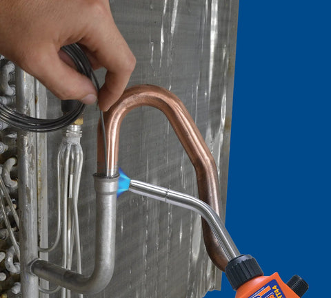 Applying Aluma-Braze All-In-One Flux Cored Aluminum Brazing Alloy for aluminum-to-copper repair with a torch flame