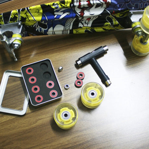 Ceramic Skateboard Bearings High Speed 608 RS Double Shielded ABEC-11 8 Pack Set with wheels and skateboard on wood table