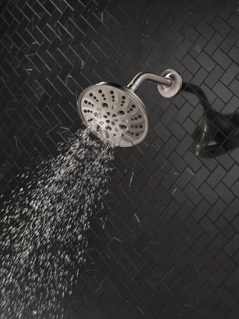 H2Okinetic Rain Shower Head With Five Settings In Stainless Finish Touch Clean Nozzle System spraying water in a tiled shower