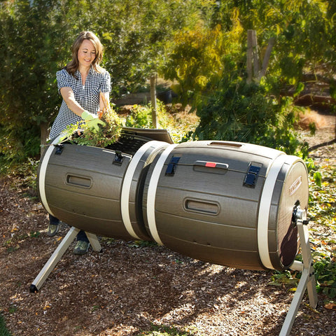 Double Bin Rotating Composter With Two 50 Gallon Barrels For Nonstop Composting in outdoor garden setting