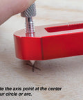 Hand adjusting Tough As Nails Aluminum Woodworking Compass Scriber on wood surface for precise arc marking.