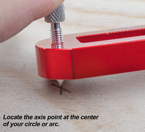 Hand adjusting Tough As Nails Aluminum Woodworking Compass Scriber on wood surface for precise arc marking.