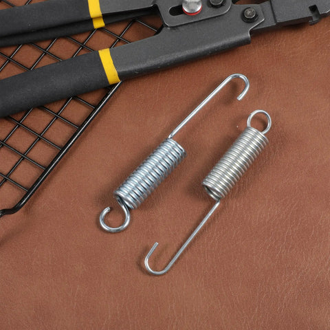Pro Quality 4.5 Inch Recliner Springs 2 Pack Stainless Steel Tension Parts For Home Furniture on leather background with tools.