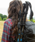 Lightweight Carbon Fiber Trekking Poles Set Of 2 With Quick Adjustable Locks attached to backpack, blue accents visible