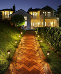 Six Pack Solar Pathway Lights Outdoor 25 Lumens Warm White 3000K IP65 Weatherproof Metal And Glass Landscape Lights illuminating a walkway