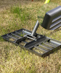 Heavy Duty Lawn Leveling Rake With Extra Long 60 Inch Steel Handle and 17 By 10 Inch Ground Plate on grass surface