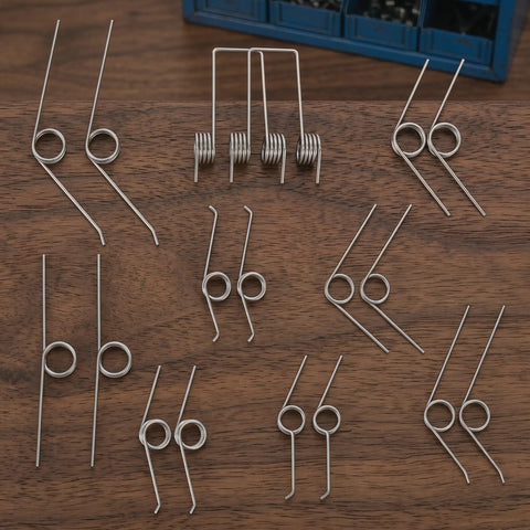 Packove 36 Pack Heavy Duty Torsion Spring Kit For Garbage Can Lid Replacement With 9 Sizes And Smooth Automatic Closure Perfect Trash Bin Repair Parts For Easy Home And Auto Waste Management, assorted steel springs on wood
