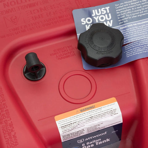 Close-up of EPA Certified Six Gallon Portable Fuel Tank for Boats, red with built-in vacuum vent valve, cap visible.