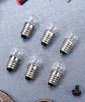 20 Pieces E10 Miniature Light Bulbs Replacement for DIY Circuits and Experiments 3.8V 0.3A displayed on a metal surface