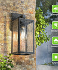 Durable Black Exterior Wall Lanterns With Hella Weatherproof Build For Backyards And Patios, mounted on textured wall, rain in background.