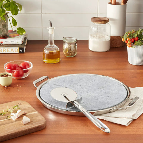 Kitchen counter with 13 Inch Soapstone Pizza Stone With Stainless Steel Tray And Cutter, Silver, showcasing durability and design.