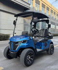 Rolling In Style Two Seater Electric Golf Cart With 48V Lithium Battery And No Sweat All Terrain Handling In Bright Blue parked on street.