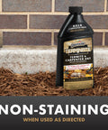 Termite And Carpenter Ant Killer Concentrate 32 Ounces Outdoor Barrier Spray bottle in garden mulch by home foundation