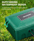 Green outdoor weatherproof electrical box with waterproof cord protector on wet grass showcasing drainage feature