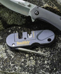 Close-up of Dual Stage Knife Sharpener With Preset Carbide And Ceramic Slots Plus Retractable Diamond Rod on granite rock.