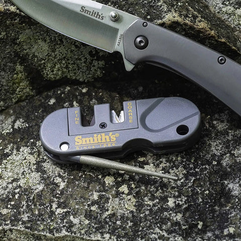 Close-up of Dual Stage Knife Sharpener With Preset Carbide And Ceramic Slots Plus Retractable Diamond Rod on granite rock.