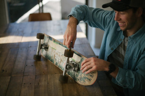 Person maintaining skateboard with Chrome Steel Bearings 8x22x7mm For Skateboards And Longboards, Tempered Steel Balls.
