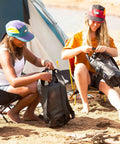 Two people using ExoDry 20L Drybag With Roll Top Compression Waterproof And Lightweight Gear Carrier for camping by the beach