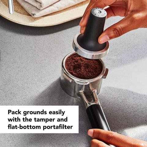 Hands using tamper on portafilter for Empire Red Metal Semi Automatic Espresso Machine With Dual Smart Temperature Sensors And 58mm Commercial Grade Portafilter For Consistent Barista Quality Espresso At Home