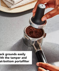 Premium Metal Semi Automatic Espresso Machine With Dual Smart Temp Sensors And 58Mm Commercial Portafilter using a tamping tool on coffee grounds.