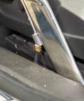 Stainless steel crevice tool with brass spray jet cleaning a car vent, showcasing the crevice tool for tight spaces and hard to reach crannies.