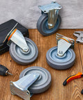 Five Inch Rubber Caster Wheels With Two Swivel And Two Rigid Rollers Non Marking Silent Drive Built Tough Heavy Duty Rigging For Smooth Cruising Upgrades And Top Shelf Reliability Daily on wooden surface with tools.