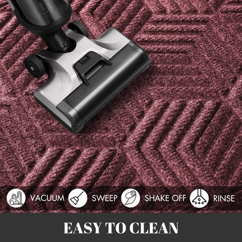 Vacuum cleaning an All Season Waterproof Front Door Mat With Drainage Holes For Indoor Outdoor Use Heavy Duty Non Slip Doormat 29.5 By 17 Inches Red.