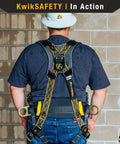 Solid As A Rock Full Body Fall Protection Safety Harness With Cushioned Lumbar Pad Multiple D Ring Attachment Points Quick Lock Buckles ANSI OSHA Certified Job Site Ready Work Gear With Durable Tool Loops And Phone Pocket worn by a worker in a gray shirt and white hard hat