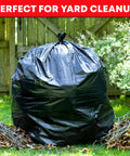 Heavy Duty Sixty Four Gallon Trash Bags Black Garbage Containers Value Pack Of Fifty With Secure Tie Tops holding yard debris outdoors.
