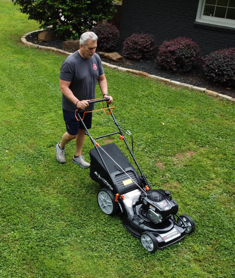 Self Propelled Lawn Mower With 150cc Briggs And Stratton Engine ReadyStart 22 Inch Steel Deck 3 In 1 Mulch Bag Side Discharge Or Rear Bag 12 Inch High Rear Wheels Solid Traction For Flat Or Sloped Lawns mowing grass on a sloped yard