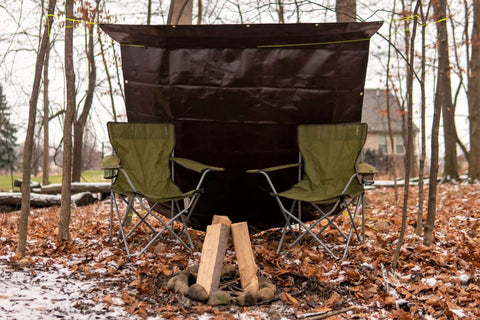 Two green camping chairs under a brown Heavy Duty Poly Tarp Cover 16 Mil and 10 Mil with Grommets and Reinforced Edges, 6 x 8 Feet
