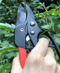 Badass Heavy Duty Anvil Pruning Shears 8 Inch Blade Ratchet Action Pruner cutting through a branch in a garden.