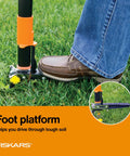 Stand Up 3 Claw Weed Puller With 39 Inch Ergonomic Handle foot platform being used on grass