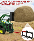 49 Inch Hay Bale Spear Attachment With Beefy 2000 Lb Capacity Quick Attach For Bobcat Tractors And Skid Steer Loaders lifting a hay bale