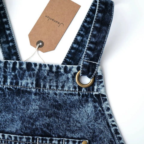 Close-up of blue-black denim apron straps with metal ring, featuring Denim Apron For Men With Towel Loop And Tool Pockets.