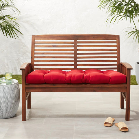 Red Tufted Outdoor Indoor Loveseat Cushion on wooden bench, reversible and comfy, 44x19x5 inches, weatherproof and fade resistant