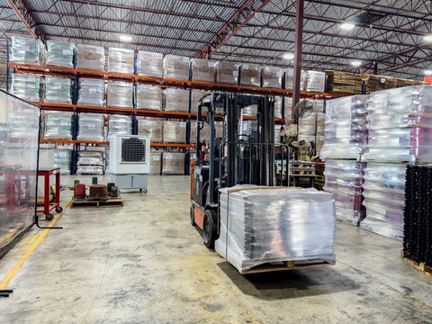 Heavy Duty Evaporative Air Cooler With Killer Cooling Power, Variable Speeds For Patios And Barns, Cools 2500 Square Feet Smooth in warehouse with stacked pallets.