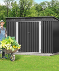Gardener beside a 9x4 Outdoor Storage Shed With Windows And Lockable Double Doors Tough As Nails Steel Construction Sloped Roof.