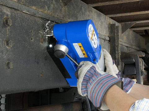 Person using Ultra Low Profile Right Angle Magnetic Drill Fabricator Kit on metal surface for precise cutting.