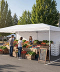 10x20 Pop Up Canopy Tent With 6 Removable Sidewalls, One Push Setup Party Gazebo For Outdoor Weddings, Parties And Events, Waterproof UV Protected, 3-Height Adjustable Easy Setup, Carry Bag Included set up at a farmers market with fresh produce displayed underneath. Visible are boxes of assorted vegetables and an outdoor parking lot setting.