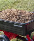 Tow Behind Poly Dump Cart With 10 Cu Ft Bed And 350 Lb Load Capacity, rust resistant poly bed, filled with mulch.