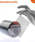 Hand holding Self Adhering Window And Screen Repair Tape 2x33ft Fiberglass Patch DIY Friendly Easy Cut And Apply All Weather Indoor Safe Gray