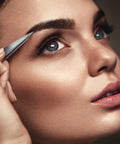 Using Pointed Tweezers Pro Grade High Carbon Stainless Steel Needle Nose Fine Point for precision hair removal on eyebrows.