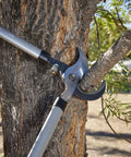 Super Duty 32 Inch Bypass Lopper with MAXFORGED Steel cutting thick branch on tree, showcasing long lasting sharp edge.
