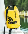 All In One Boating Safety Dry Bag Kit With IP68 Waterproof Flashlight resting on a boat railing, yellow color, size 3