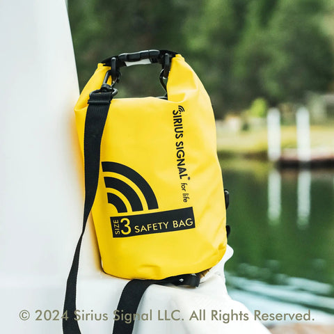 All In One Boating Safety Dry Bag Kit With IP68 Waterproof Flashlight resting on a boat railing, yellow color, size 3