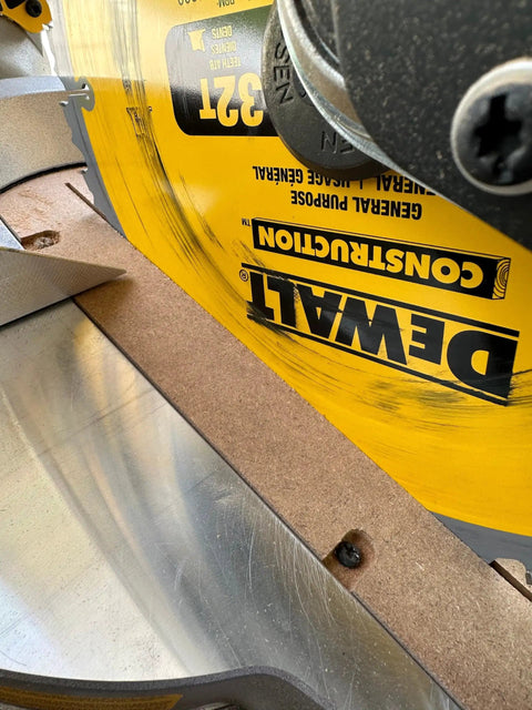 Zero Clearance Insert For Sliding Compound Miter Saws showing brown insert installed on saw with DeWalt blade; made in USA